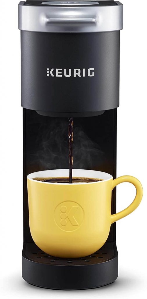 keurig k mini coffee maker in black pictured with yellow mug.